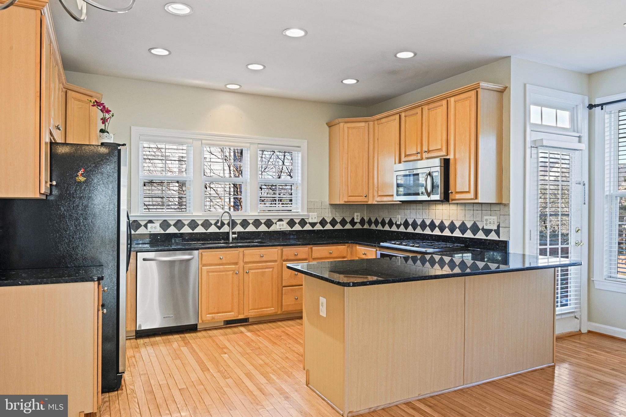4150 Jeremy Grv Court Fairfax, VA 22030 - Photo 11 of 26 a kitchen with granite countertop a sink and a refrigerator
