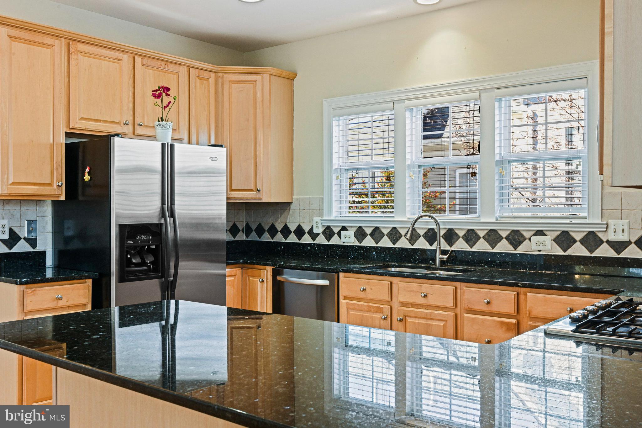 4150 Jeremy Grv Court Fairfax, VA 22030 - Photo 12 of 26 a kitchen with granite countertop a stove a sink and a refrigerator