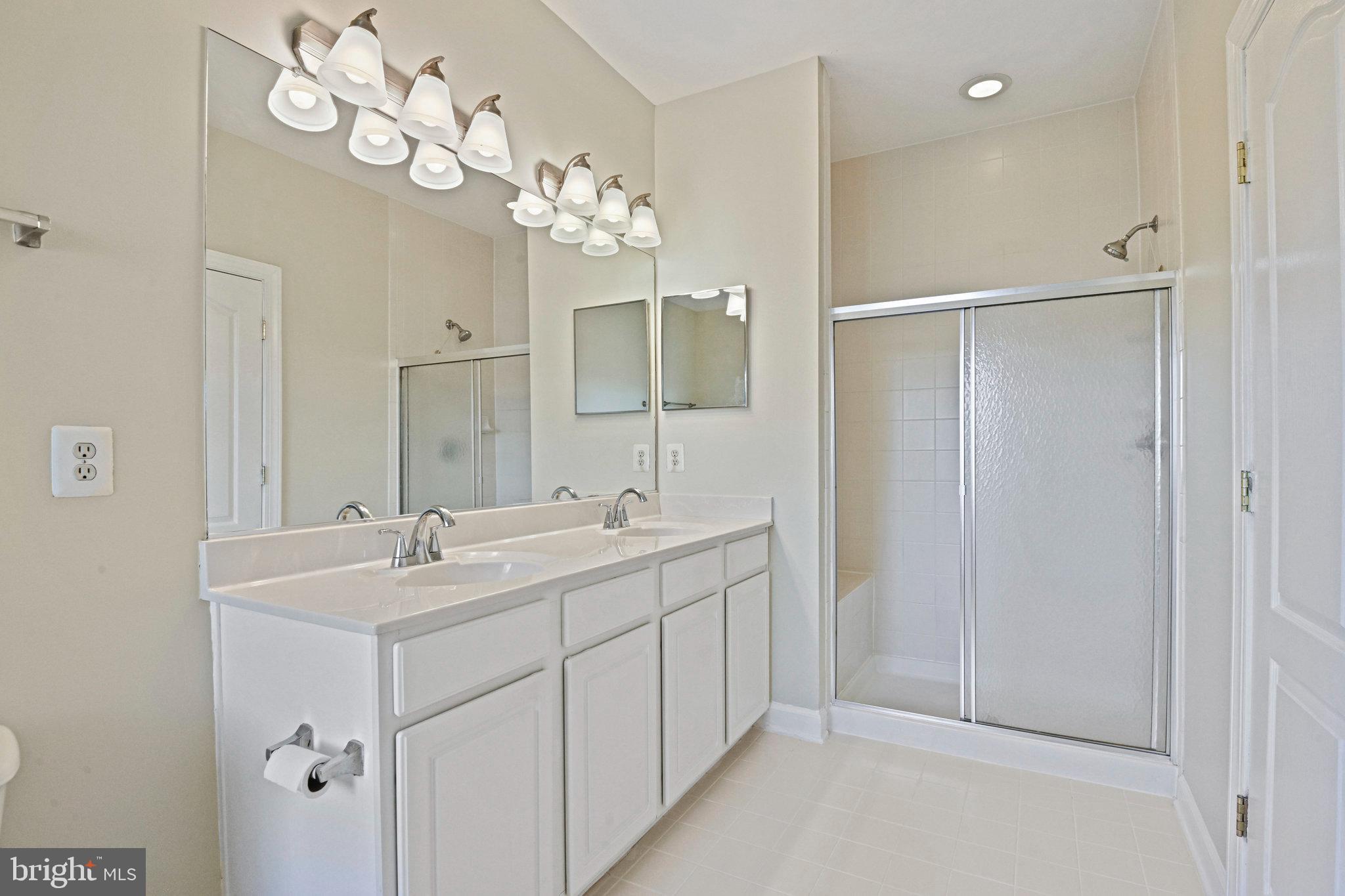 4150 Jeremy Grv Court Fairfax, VA 22030 - Photo 21 of 26 a bathroom with a double vanity sink mirror and shower