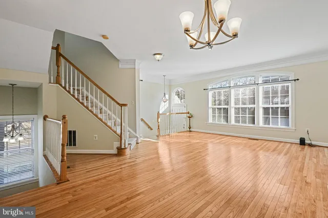 a view of kitchen with refrigerator microwave and wooden floor