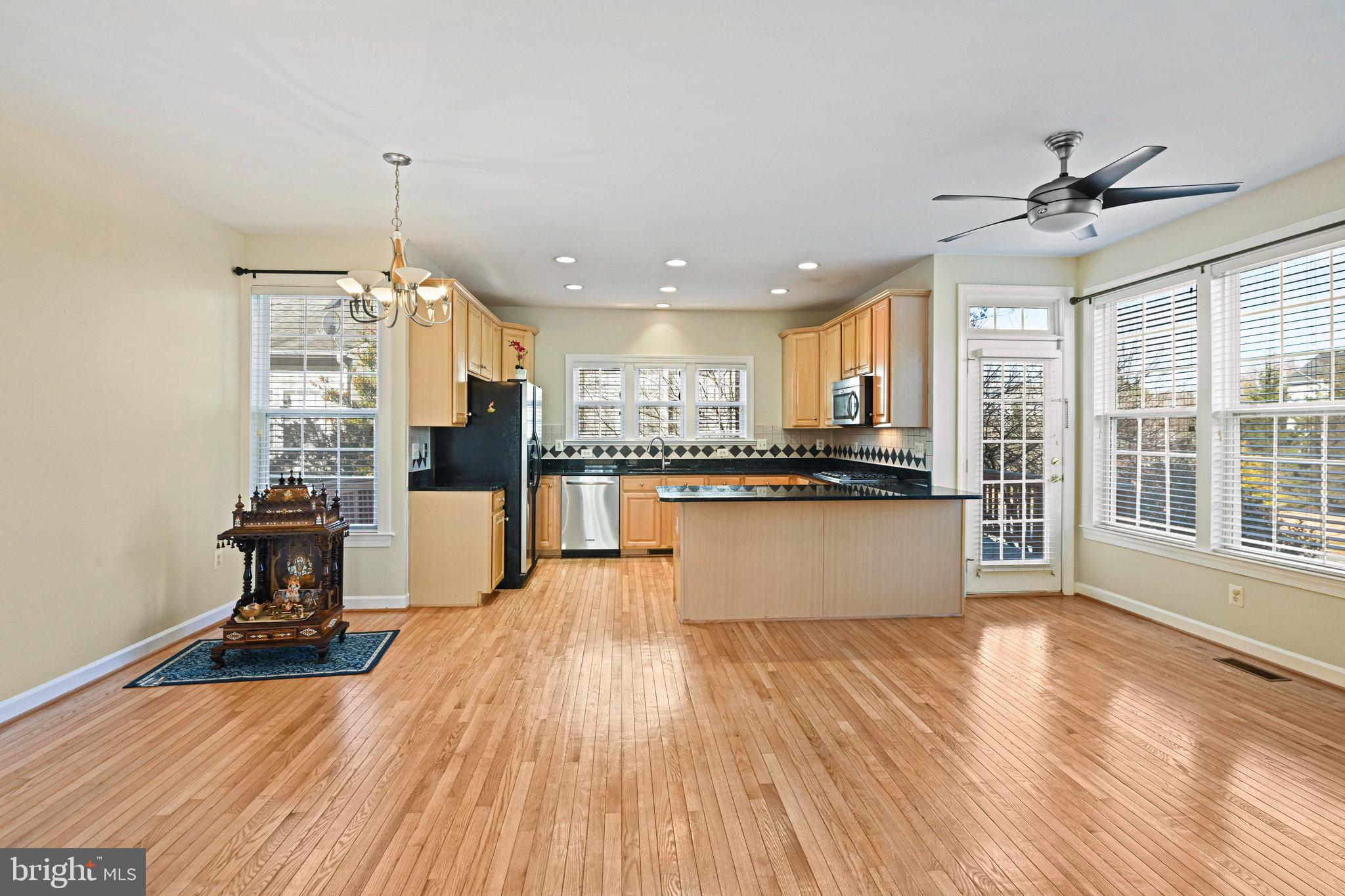 4150 Jeremy Grv Court Fairfax, VA 22030 - Photo 7 of 26 a view of kitchen with refrigerator microwave and wooden floor