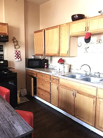 a kitchen with a sink cabinets and a window