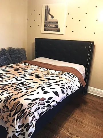 a bedroom with bed and mirror