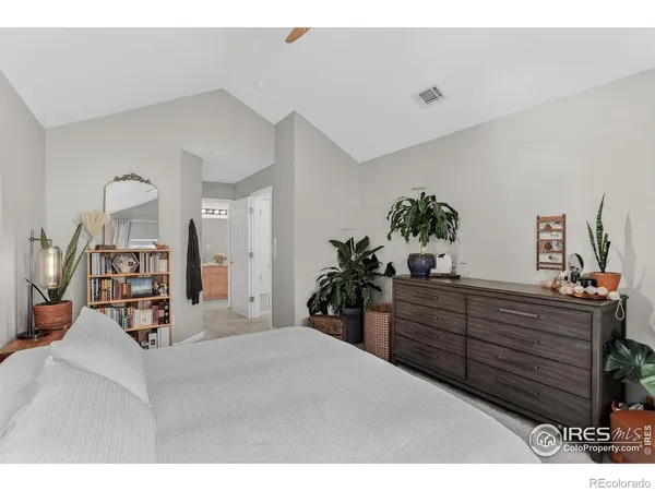 a bed room with a bed and a potted plant