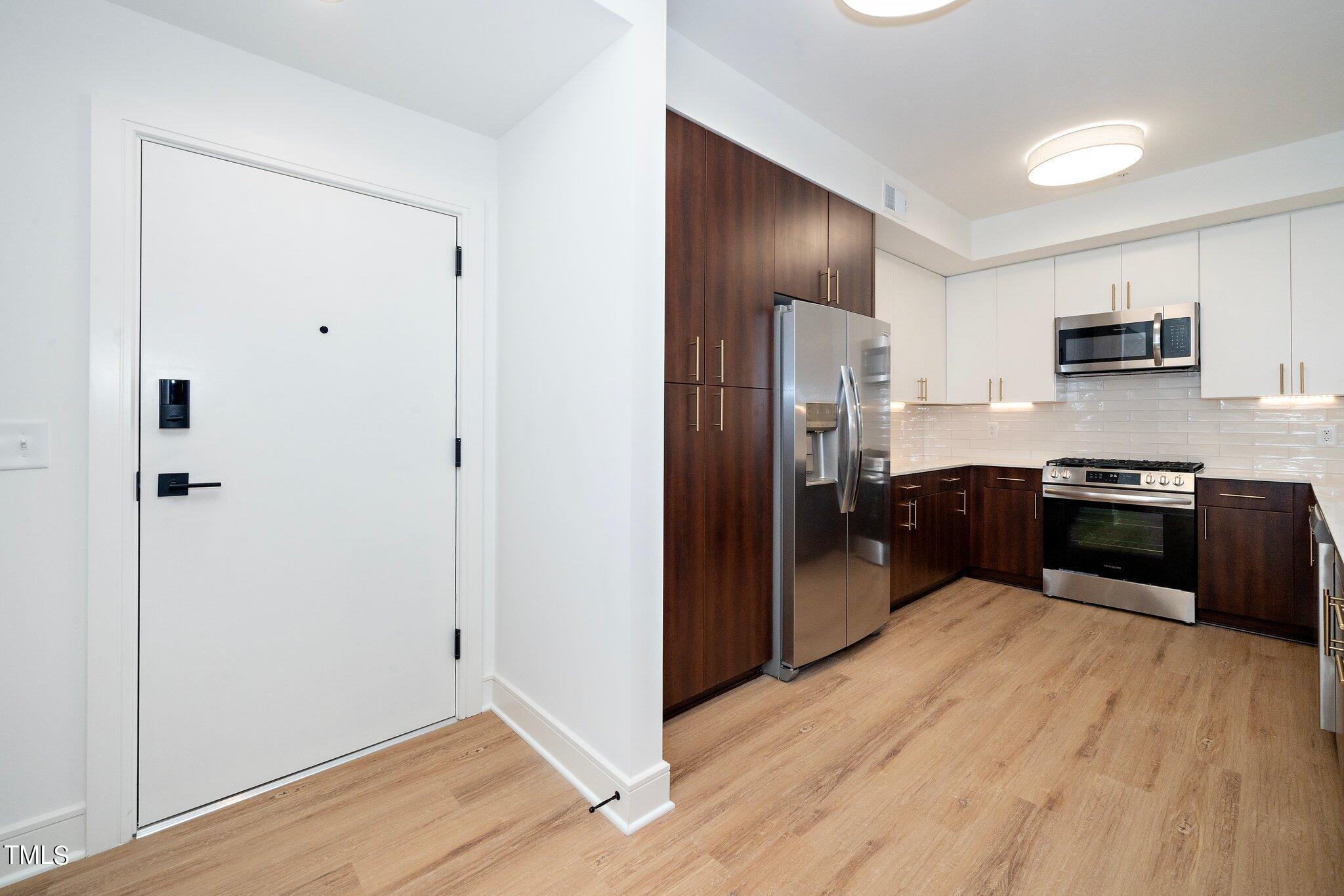 615 West Peace Street, Unit 306 Raleigh, NC 27603 - Photo 2 of 37 a kitchen with stainless steel appliances a refrigerator and a sink