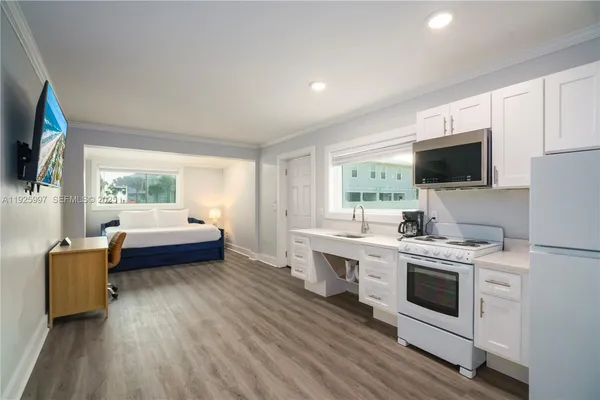a kitchen with a stove a sink and a microwave