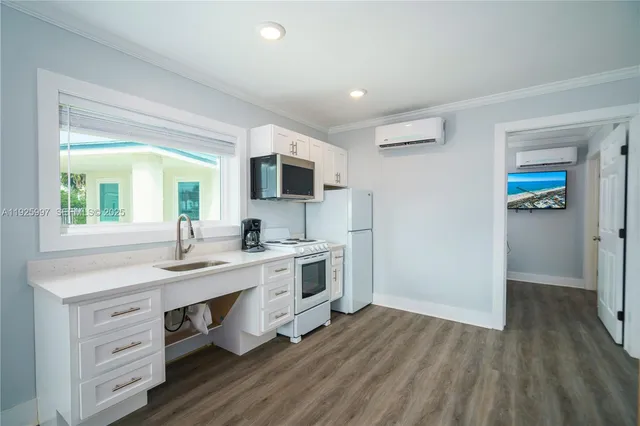 a view with cabinets a sink and a window