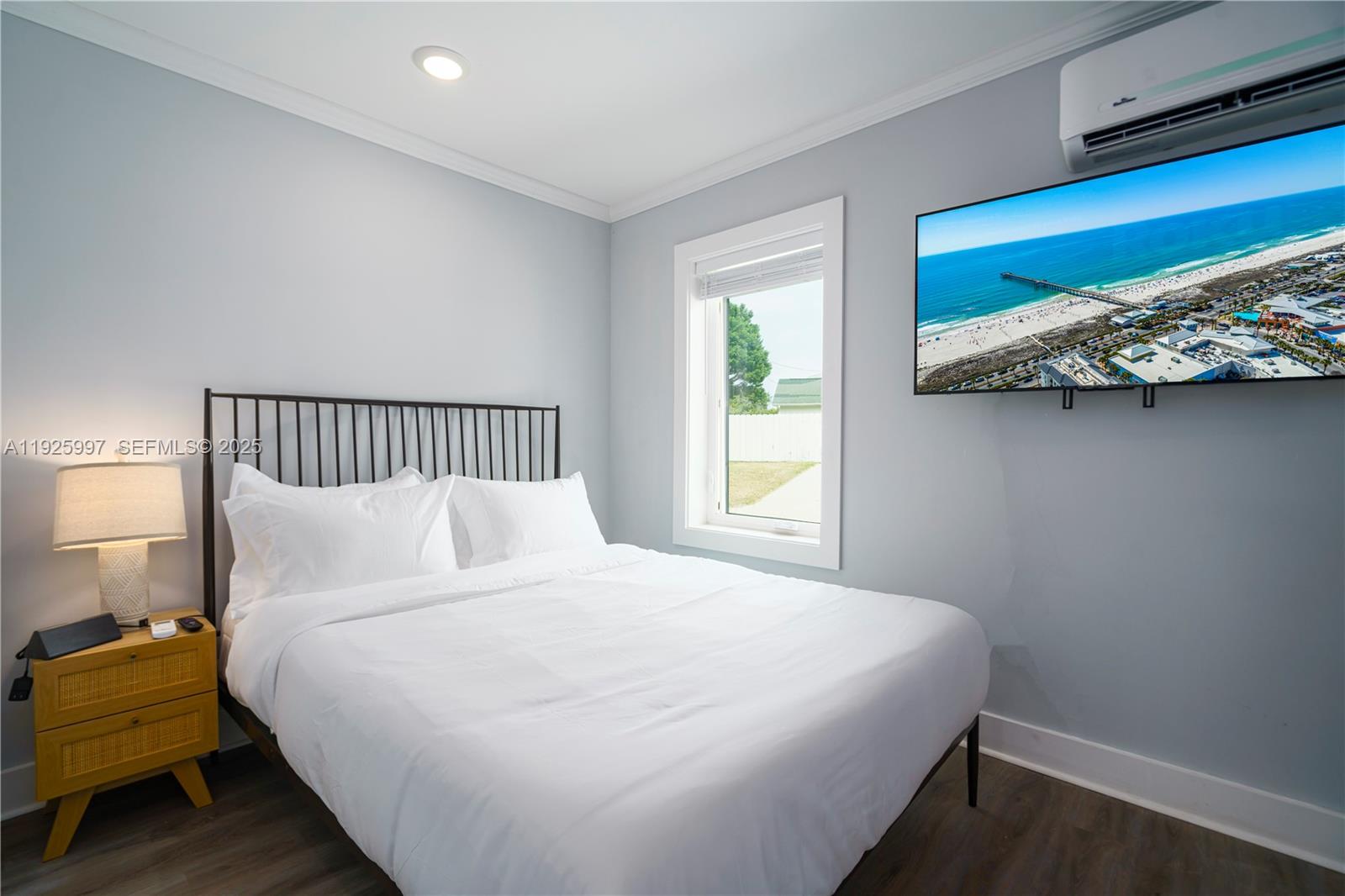 17784 Front Beach Road, Unit 16 Panama City, FL 32413 - Photo 4 of 12 a large bed sitting in a bedroom next to a window