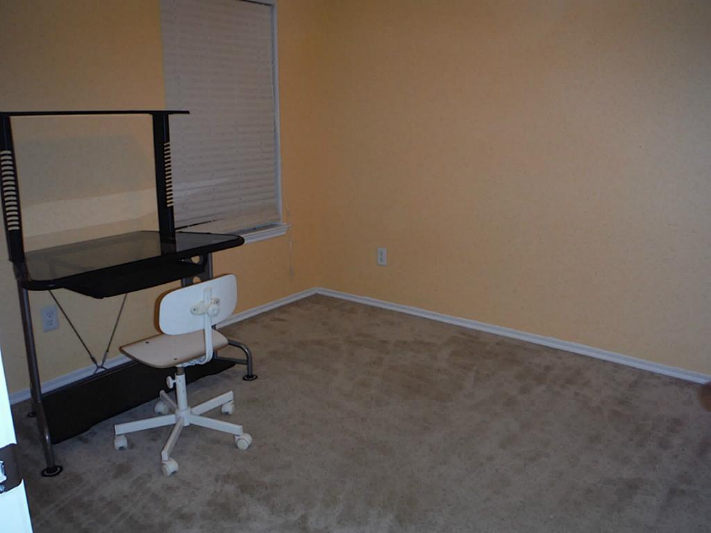 3142 Aspen Fair Trail Spring, TX 77389 - Photo 19 of 22 Cozy room with soft carpet and light walls, perfect for a home office, study or play area.