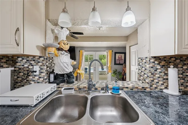 a kitchen with a sink and a stove next to a window