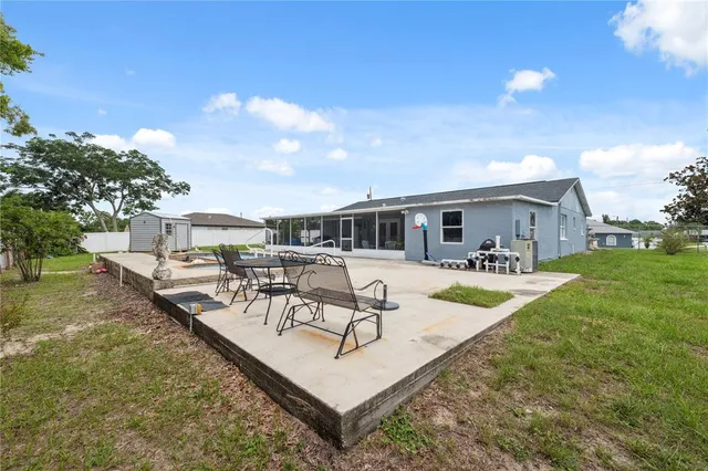 a view of a house with swimming pool and sitting area