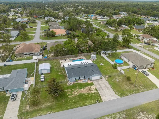an aerial view of a residential houses with outdoor space