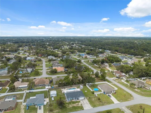 an aerial view of residential houses with outdoor space