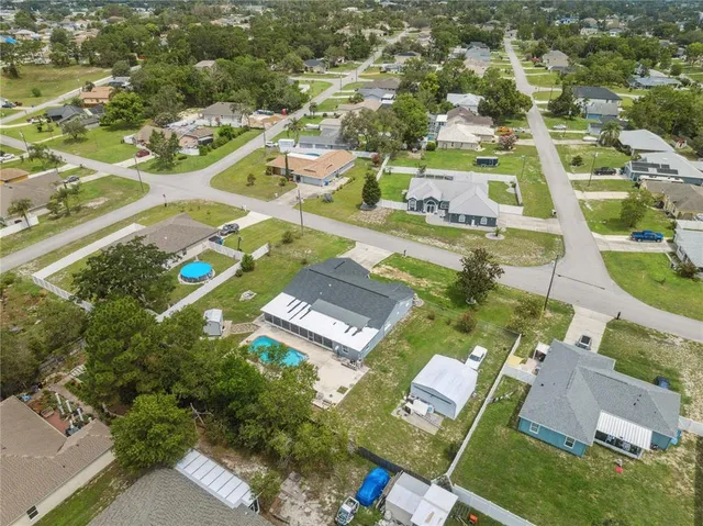 an aerial view of residential houses with outdoor space