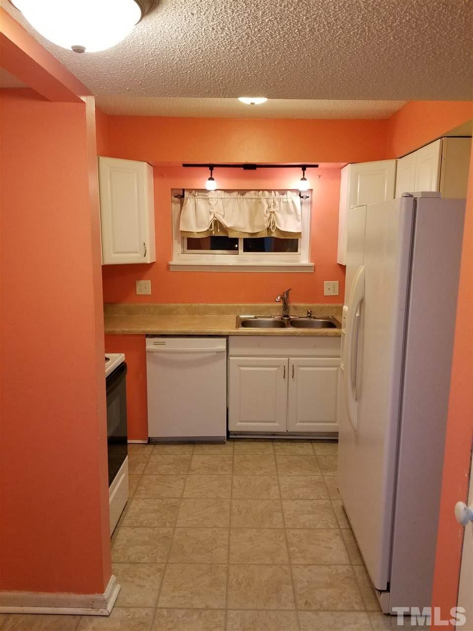 5911 Farm Gate Road Raleigh, NC 27606 - Photo 11 of 21 a kitchen with stainless steel appliances a stove and a refrigerator