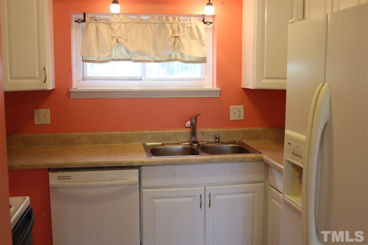 5911 Farm Gate Road Raleigh, NC 27606 - Photo 12 of 21 a kitchen with a sink and cabinets