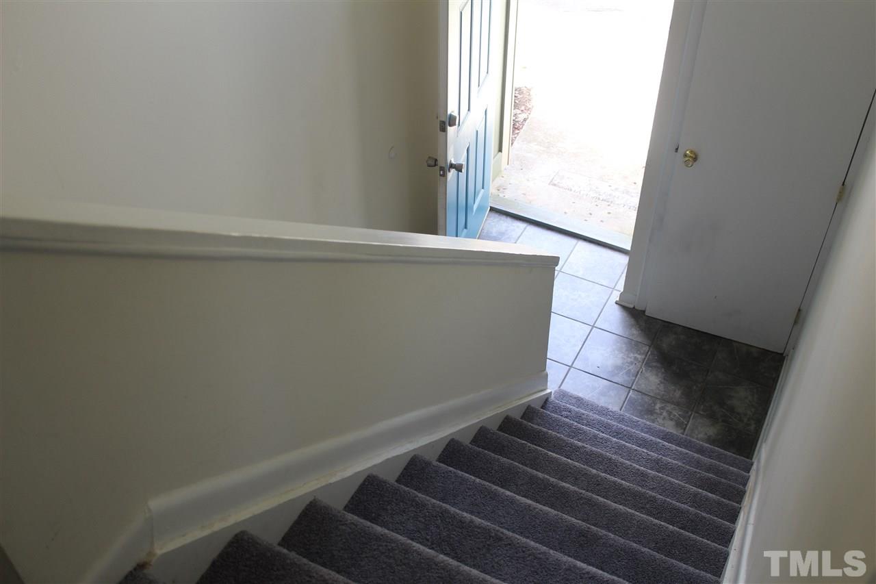 5911 Farm Gate Road Raleigh, NC 27606 - Photo 3 of 21 a view of an empty room with wooden floor and a window