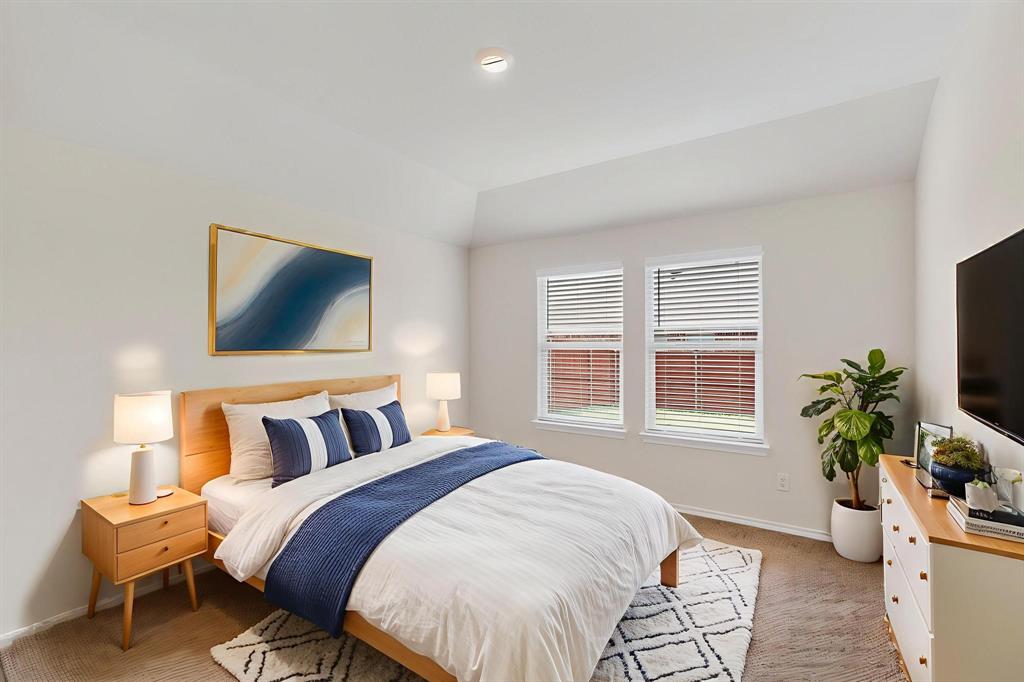 406 Regiment Road Sherman, TX 75090 - Photo 14 of 40 a bedroom with a large bed and a flat screen tv