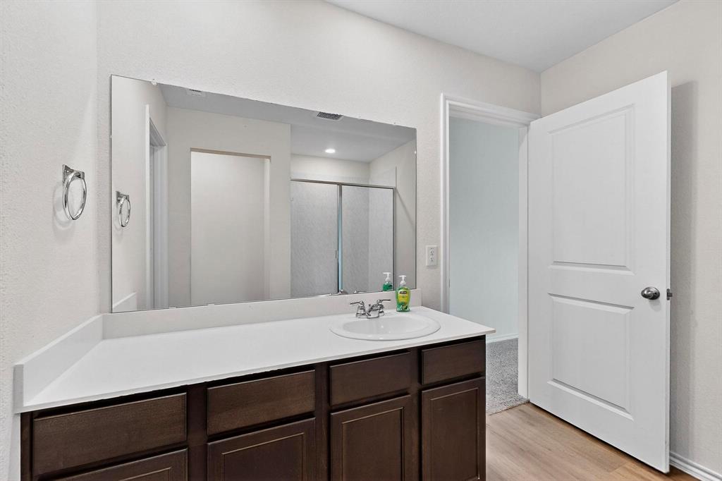406 Regiment Road Sherman, TX 75090 - Photo 17 of 40 a bathroom with a sink and a mirror