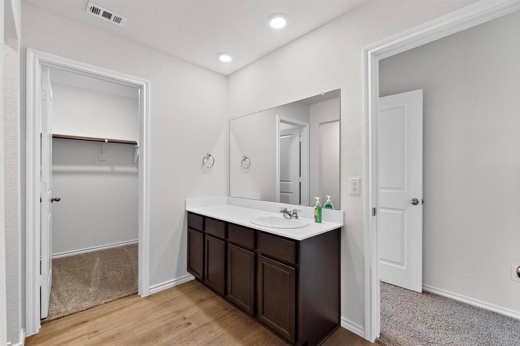406 Regiment Road Sherman, TX 75090 - Photo 18 of 40 a bathroom with a sink a mirror and a shower