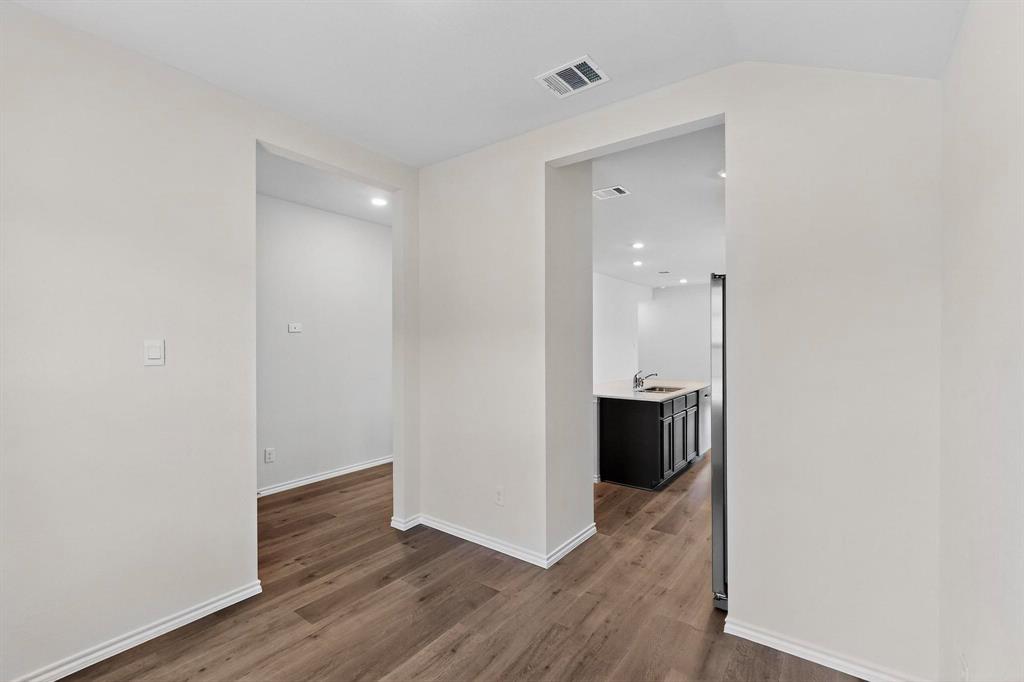 406 Regiment Road Sherman, TX 75090 - Photo 5 of 40 a view of a hallway with wooden floor and chair