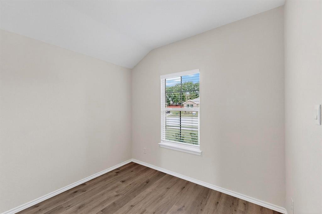 406 Regiment Road Sherman, TX 75090 - Photo 6 of 40 an empty room with wooden floor and windows