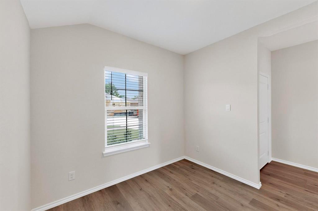 406 Regiment Road Sherman, TX 75090 - Photo 7 of 40 an empty room with wooden floor and windows