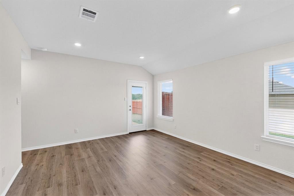 406 Regiment Road Sherman, TX 75090 - Photo 8 of 40 an empty room with wooden floor and windows