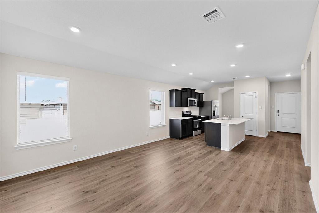 406 Regiment Road Sherman, TX 75090 - Photo 39 of 40 a view of kitchen with stainless steel appliances kitchen island sink and wooden floor