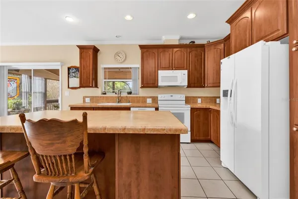 a kitchen with granite countertop a sink and cabinets