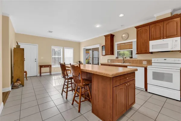 a kitchen with stainless steel appliances a stove a sink dishwasher and a refrigerator
