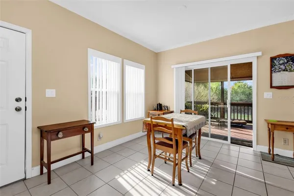 a dining room with furniture and large windows