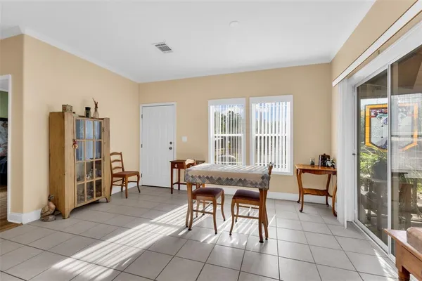 a living room with a baby crib furniture and a window
