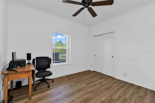 a view of a workspace with furniture and a window