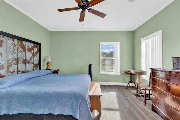 a bedroom with a bed and wooden floor