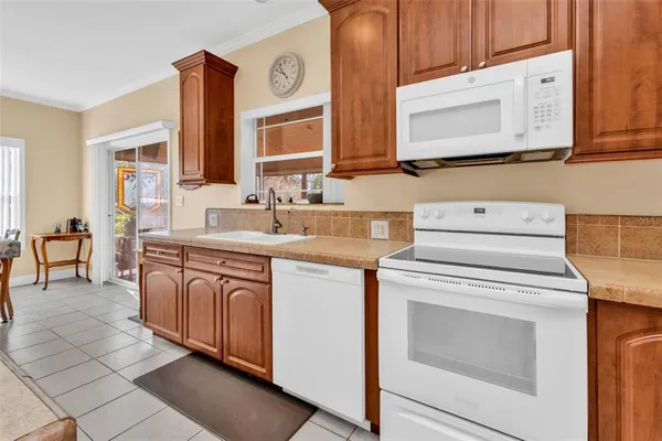 a kitchen with stainless steel appliances granite countertop a sink and cabinets