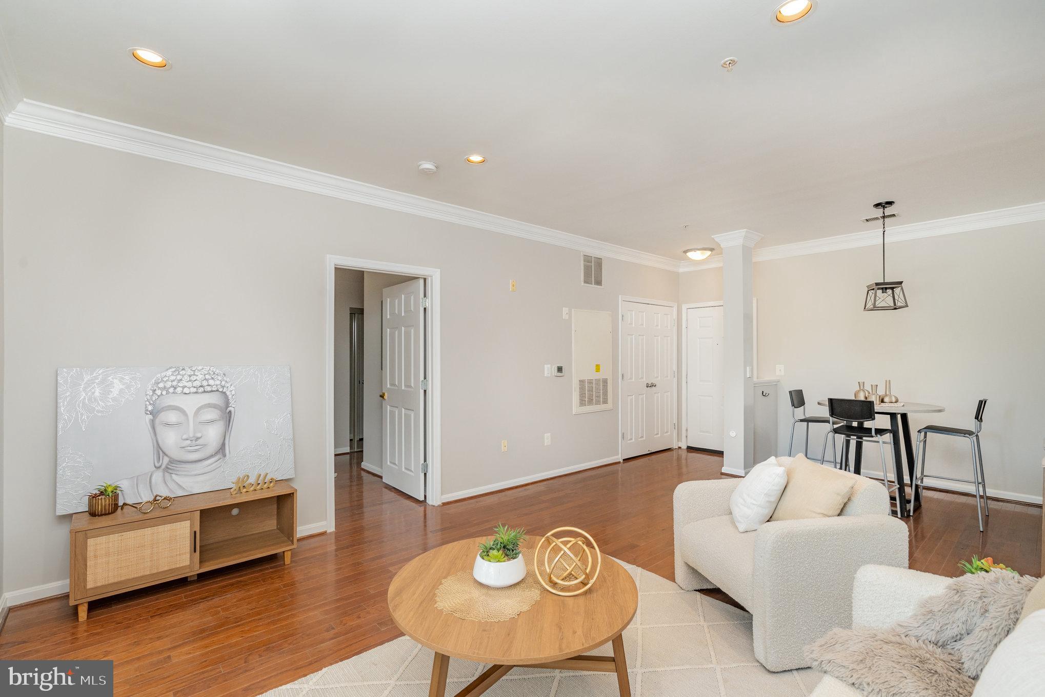 4850 Eisenhower Avenue, Unit 203 Alexandria, VA 22304 - Photo 16 of 24 a living room with furniture and wooden floor