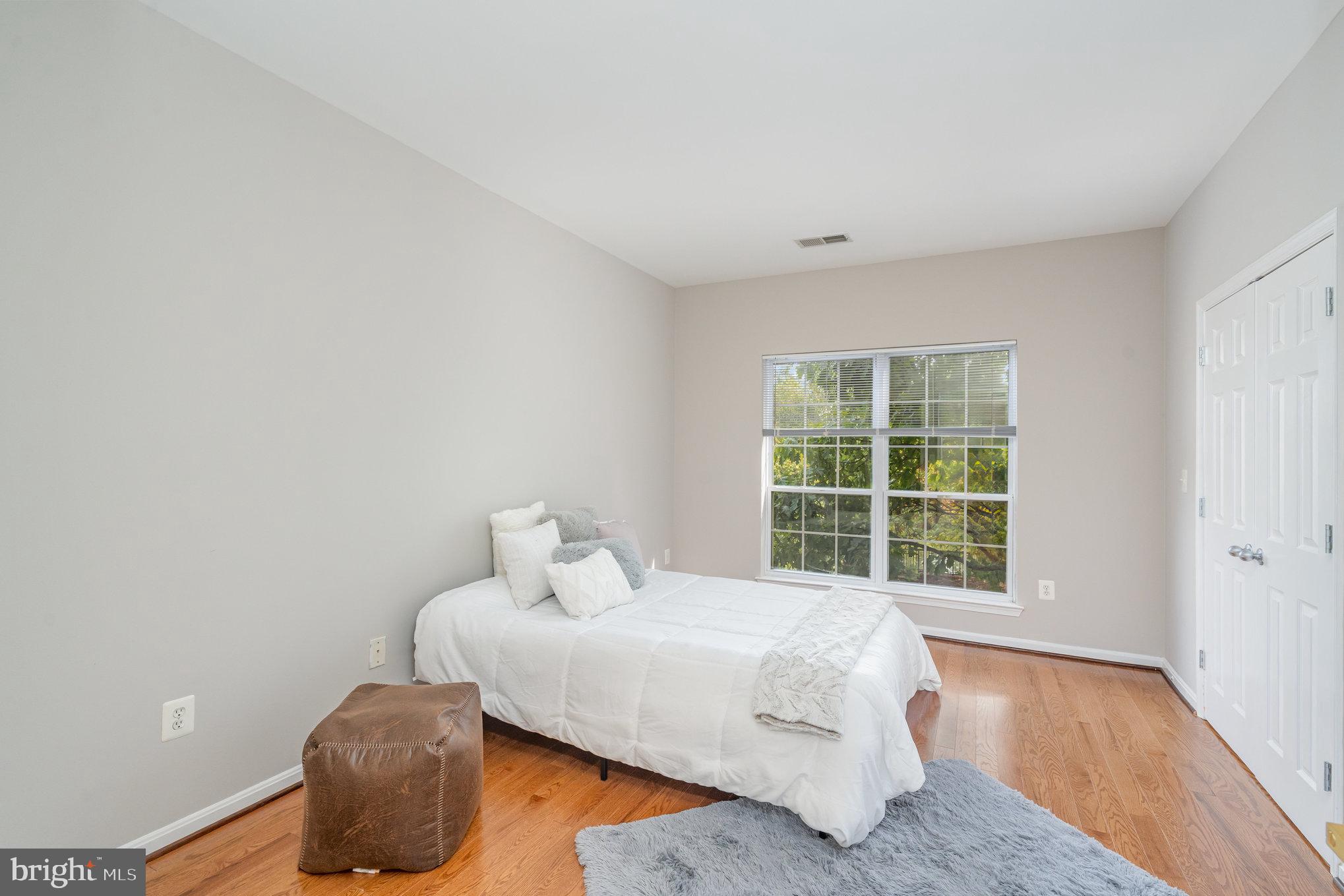 4850 Eisenhower Avenue, Unit 203 Alexandria, VA 22304 - Photo 17 of 24 a bedroom with a bed and window
