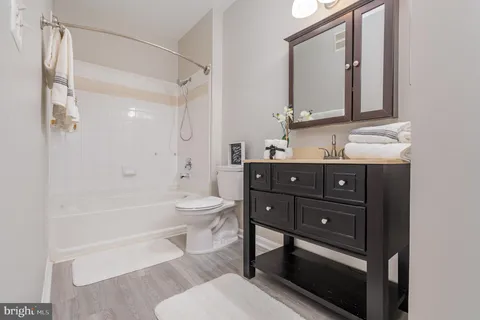 a bathroom with a toilet a sink and bathtub