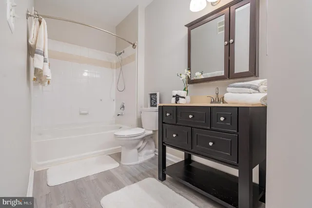 a bathroom with a toilet a sink and bathtub