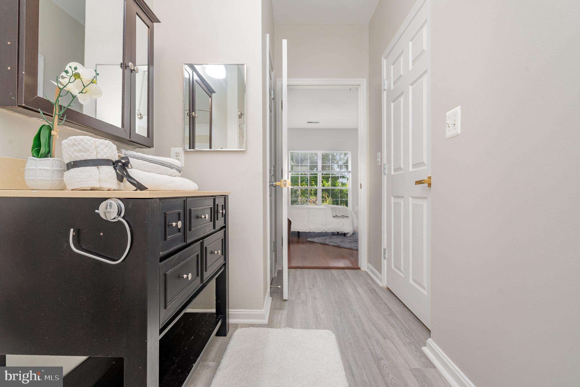 4850 Eisenhower Avenue, Unit 203 Alexandria, VA 22304 - Photo 20 of 24 a room with a sink and a mirror