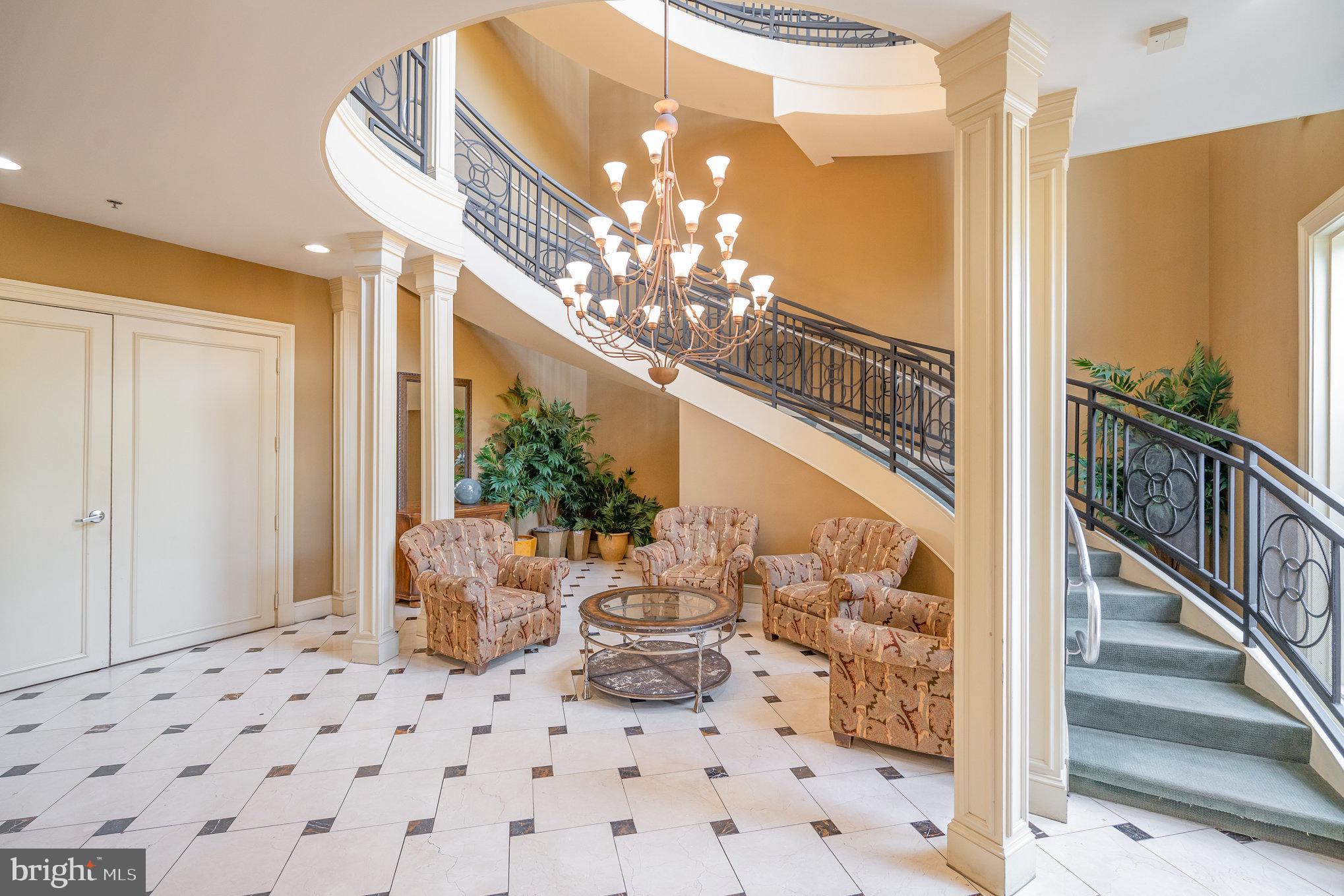 4850 Eisenhower Avenue, Unit 203 Alexandria, VA 22304 - Photo 3 of 24 a view of a hallway with dining room and chandelier