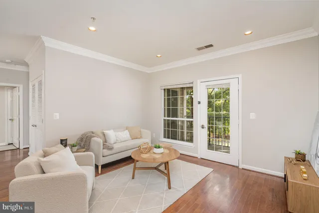 a living room with furniture and floor to ceiling windows