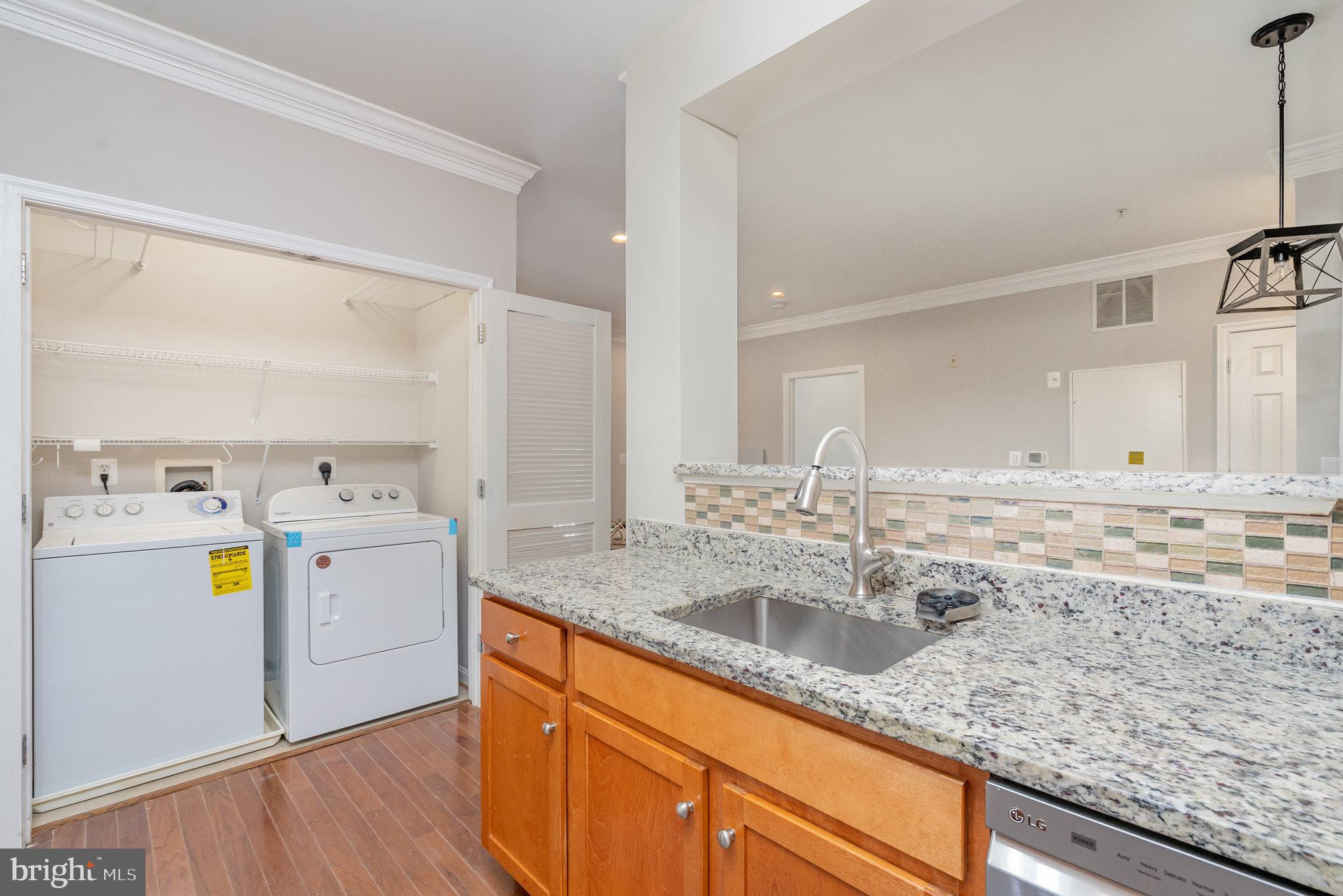 4850 Eisenhower Avenue, Unit 203 Alexandria, VA 22304 - Photo 7 of 24 a kitchen with a sink and cabinets