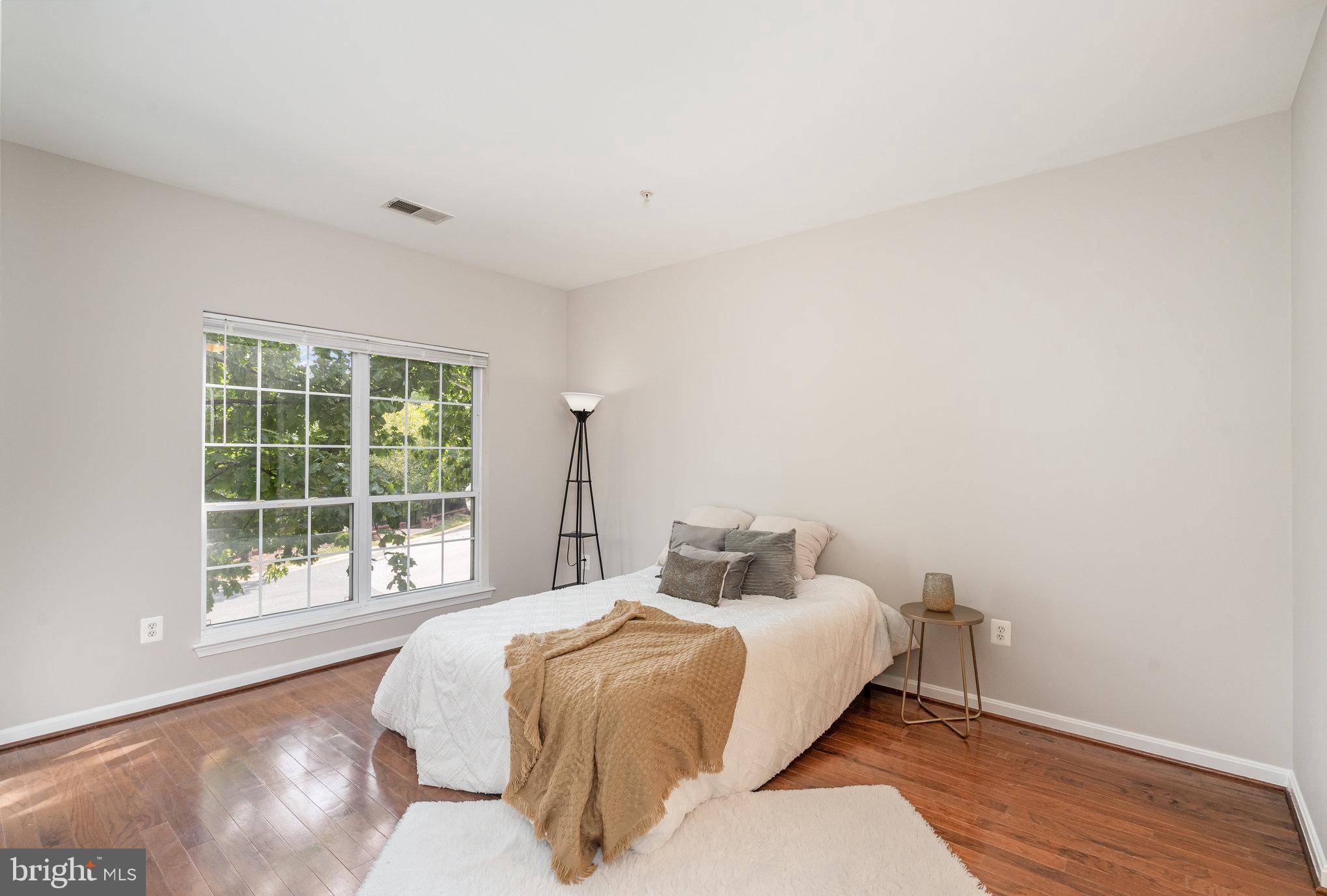 4850 Eisenhower Avenue, Unit 203 Alexandria, VA 22304 - Photo 10 of 24 a bedroom with a bed and a window