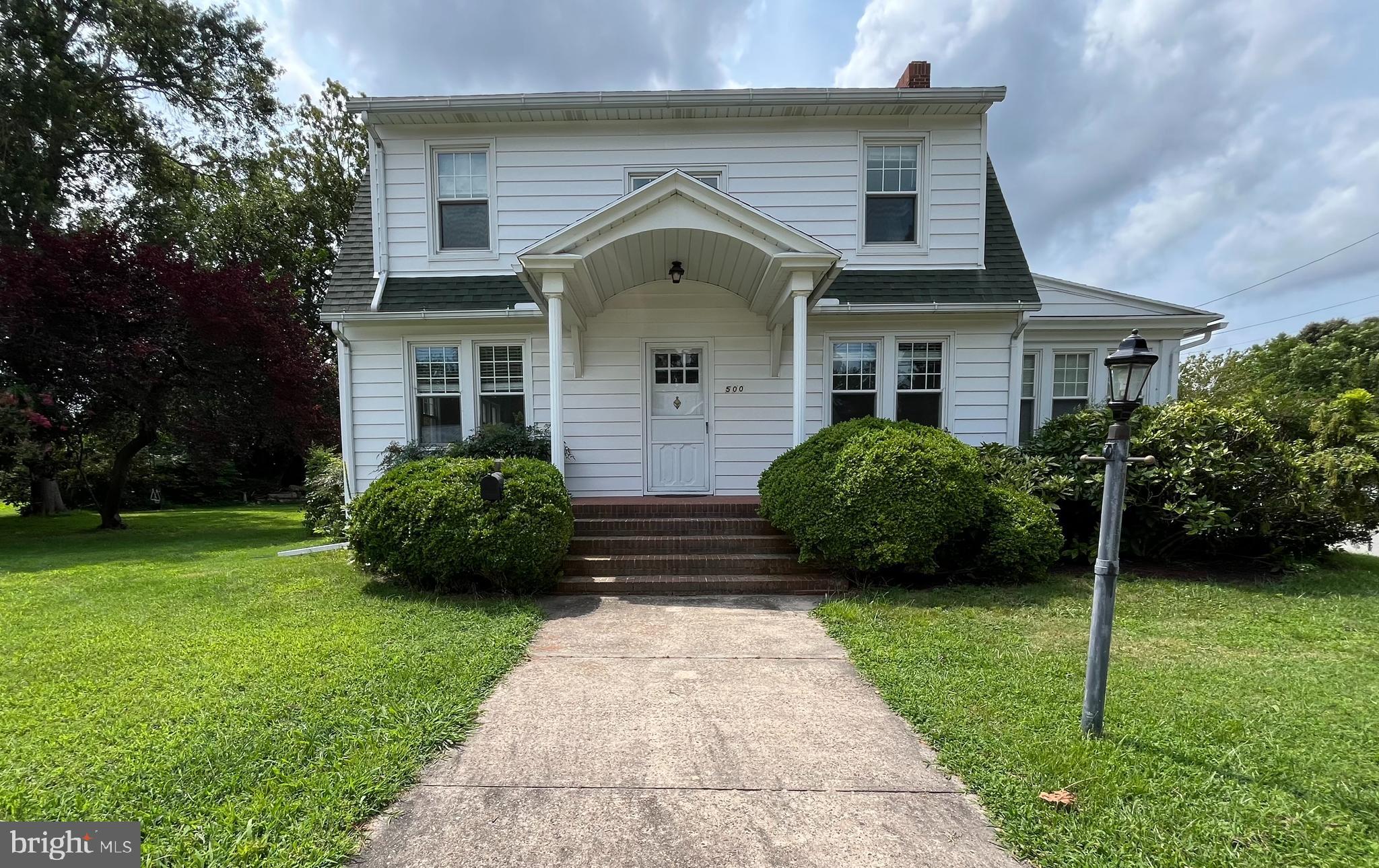 500 Delaware Avenue Delmar, DE 19940 - Photo 1 of 29 a front view of a house with a garden