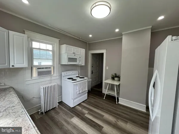 a kitchen with stainless steel appliances granite countertop a refrigerator and a stove