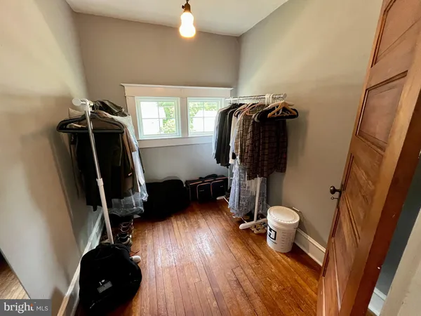 a view of a closet and wooden floor