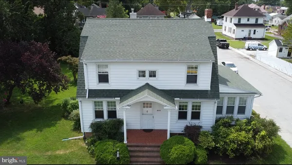 an aerial view of a house with a yard
