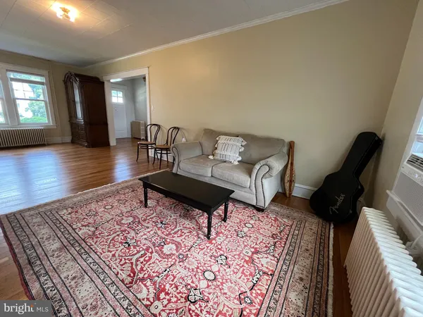 a living room with furniture and a rug